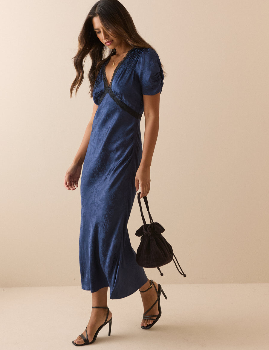 Navy blue jacquard dress with lace trim.