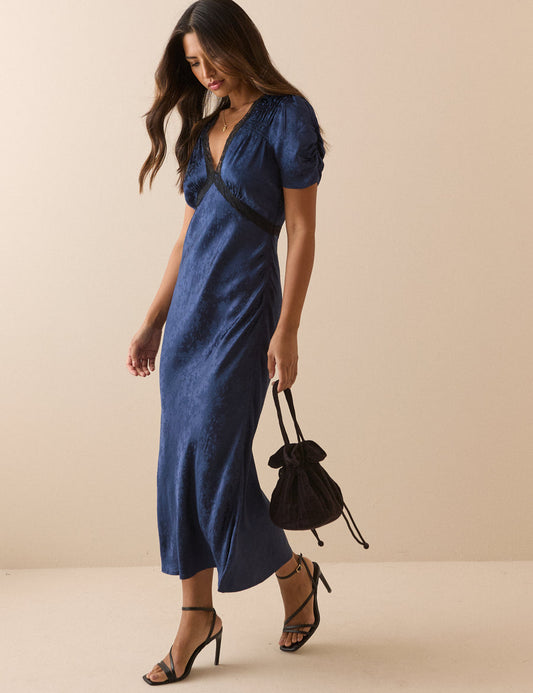 Navy blue jacquard dress with lace trim.