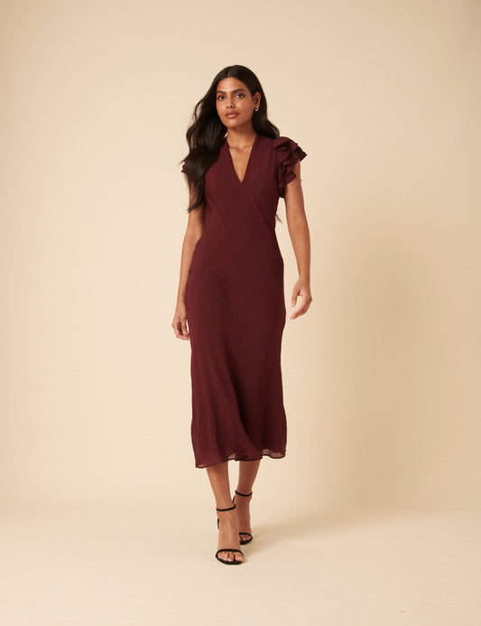 Burgundy v-neck midi dress with ruffle sleeves.