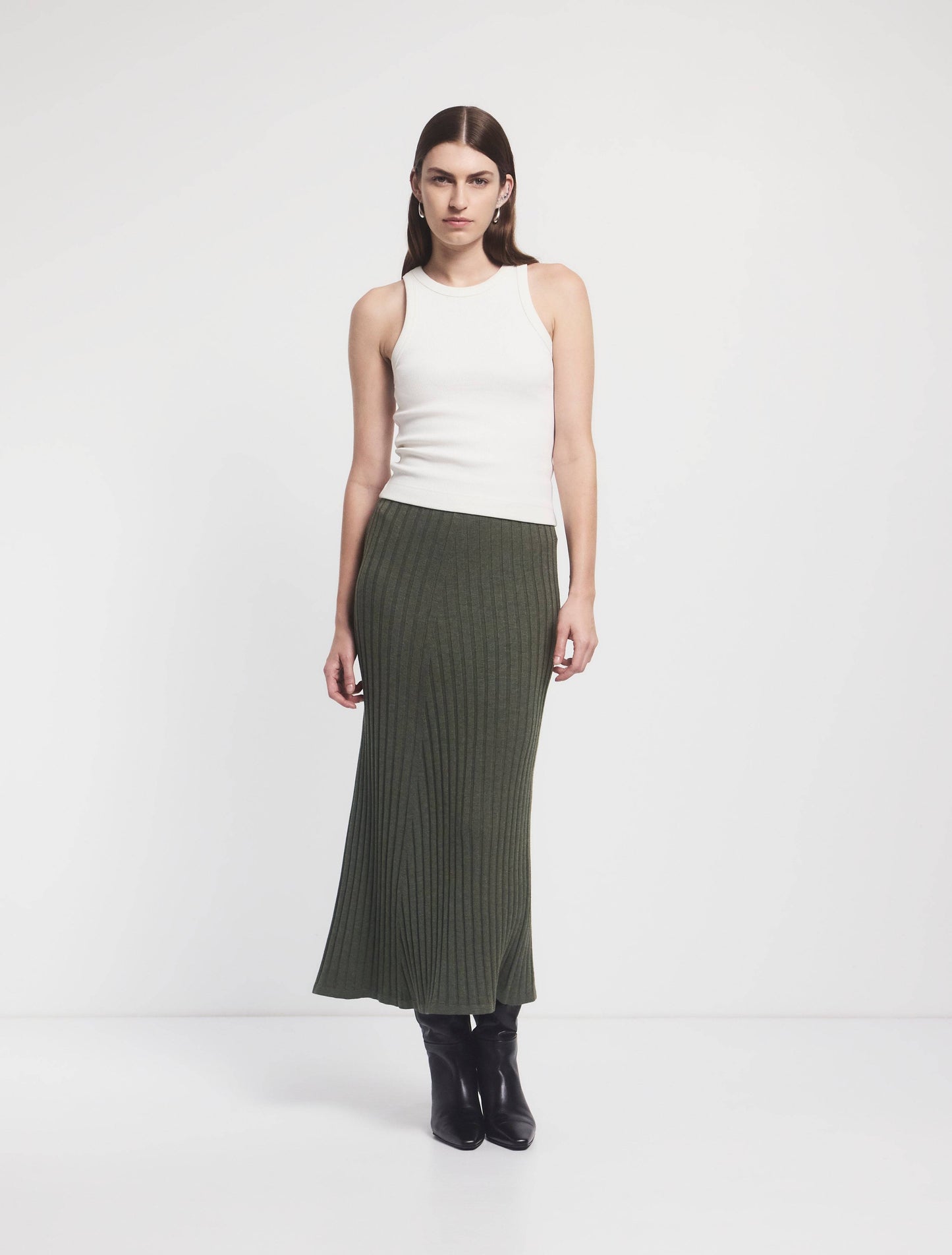 Olive green ribbed knit midi skirt with fitted waist and flared hem.