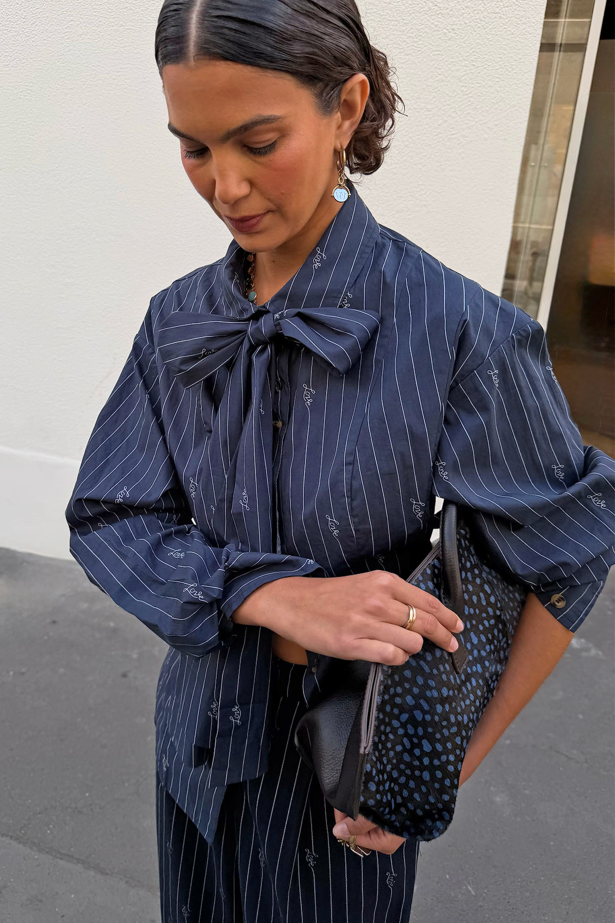 Navy pinstripe shirt with bow tie.