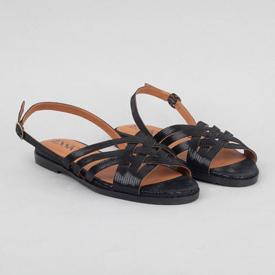 Flat metallic black slingback sandals.
