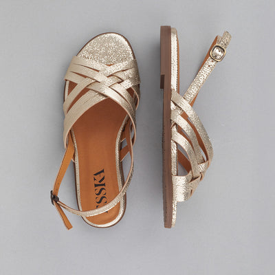 Platinum metallic leather flat slingback sandals.