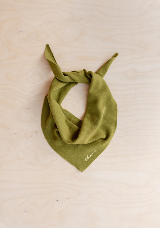 Olive green merino wool neck scarf with a soft drape and pointed ends, styled tied at the front