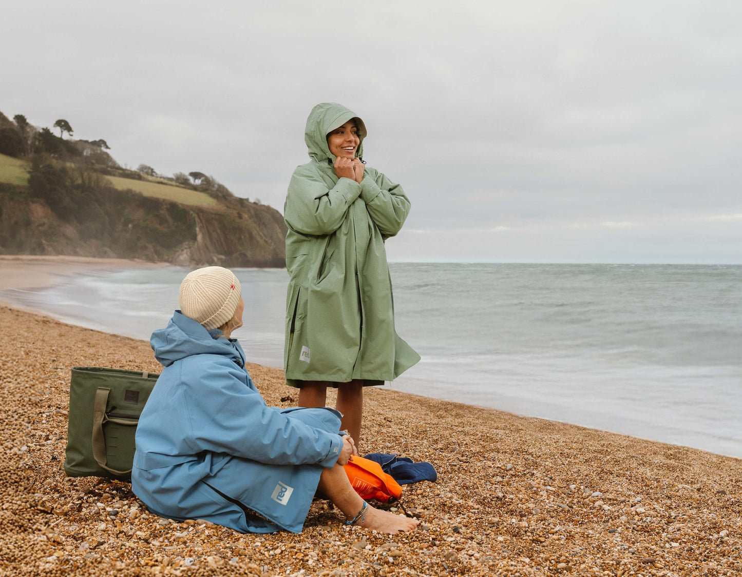 Sage green waterproof changing robe with hood.