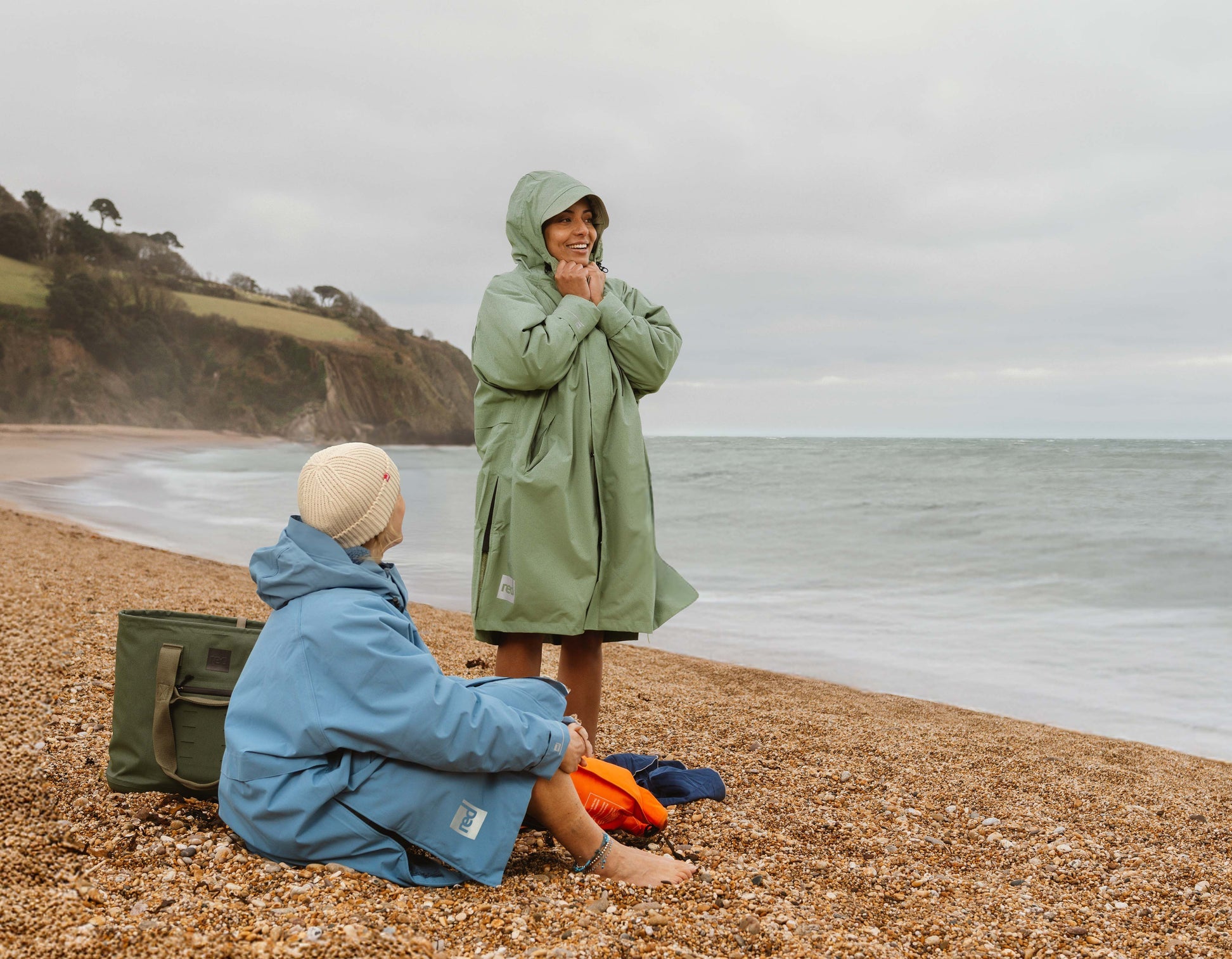 Sage green waterproof changing robe with hood.