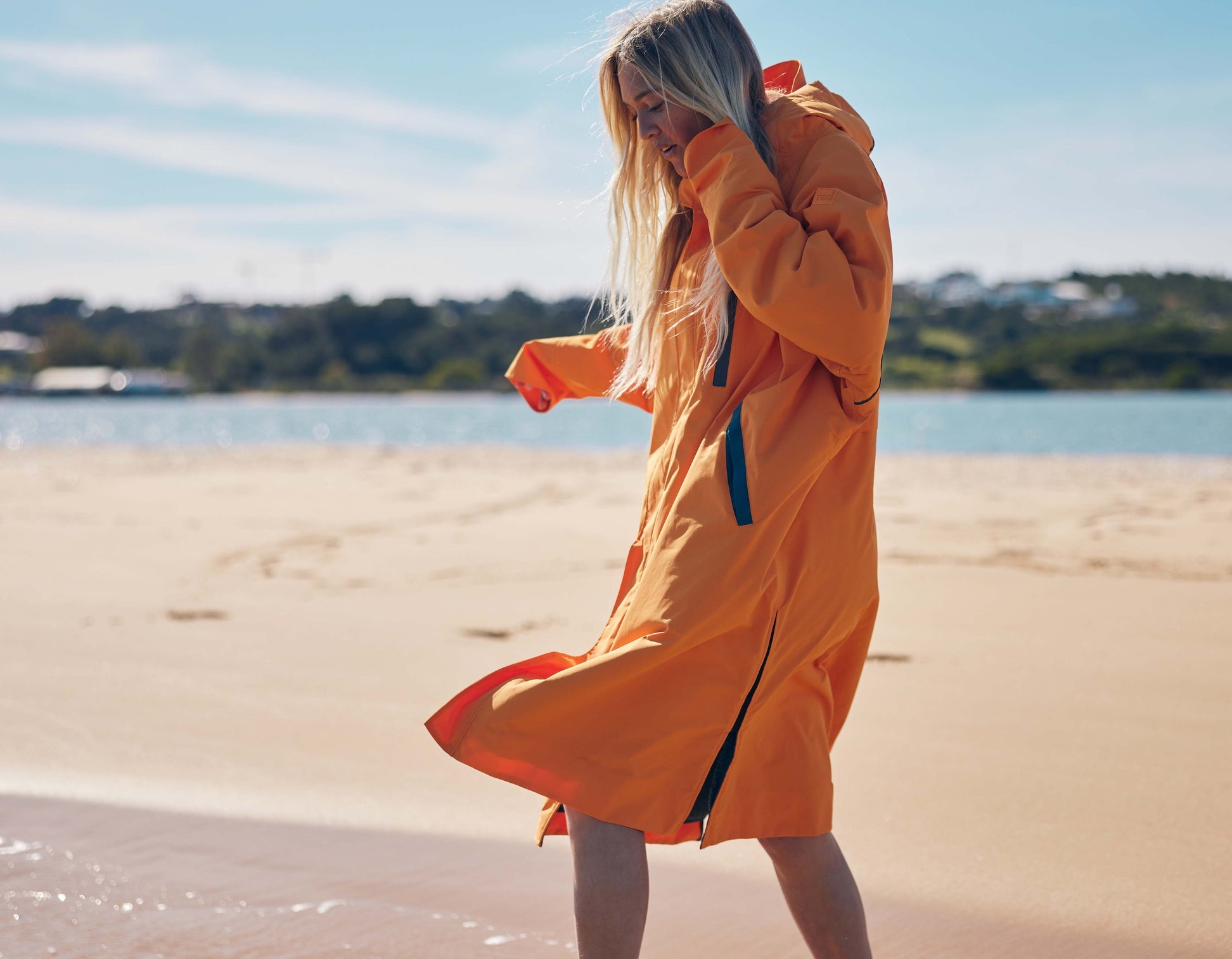 Bright orange waterproof changing robe with hood.