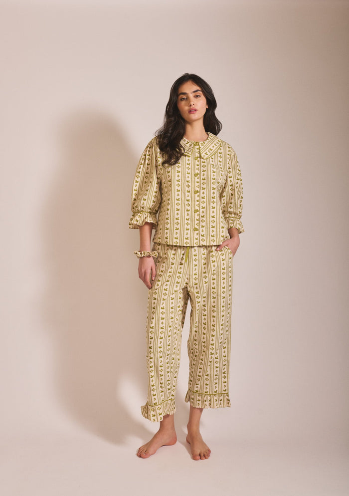Olive green and cream patterned long-sleeve pyjama set with button-up top and matching trousers.