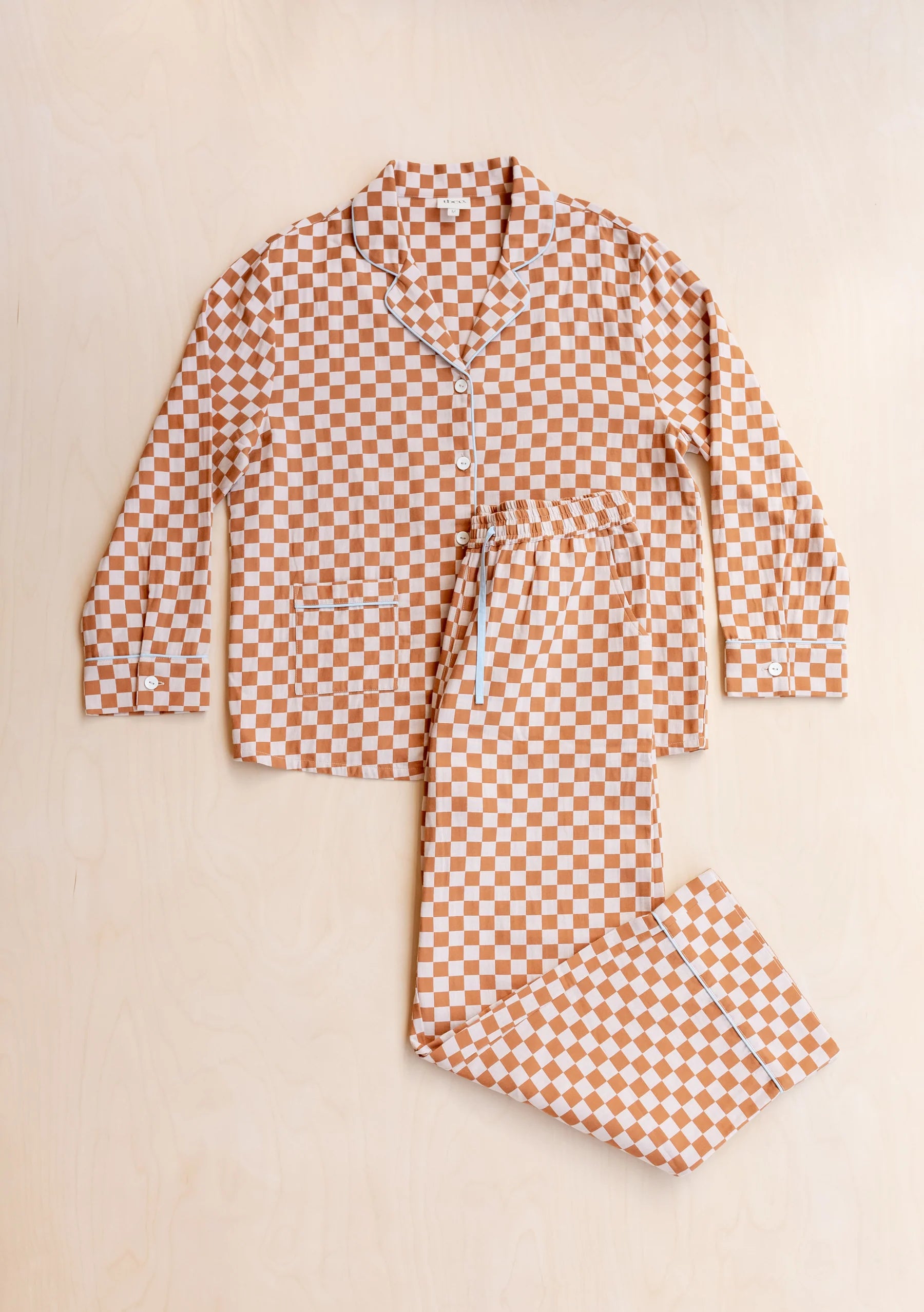 Checkered pyjama set on a beige background. Pyjamas are by TBCo and are filtered by Shop My Palette for the Light Spring, Warm Spring, Warm Autumn, and Soft Autumn colour seasons.