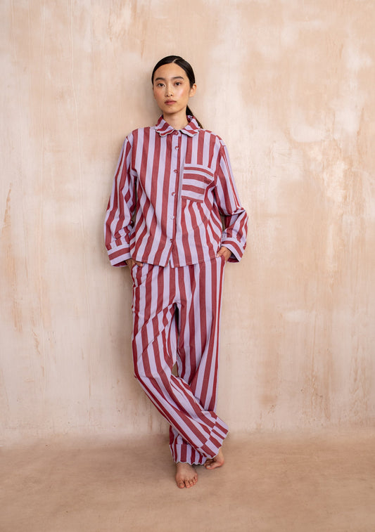 Burgundy and lilac striped cotton pyjama set with button-up long sleeve top and matching trousers.