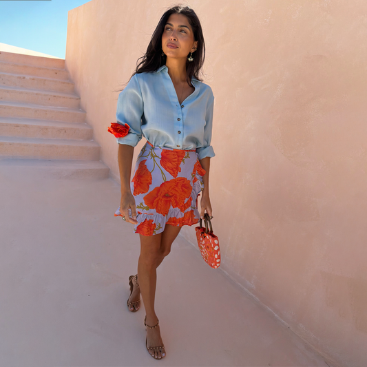 Pale blue mini skirt with orange poppy pattern.
