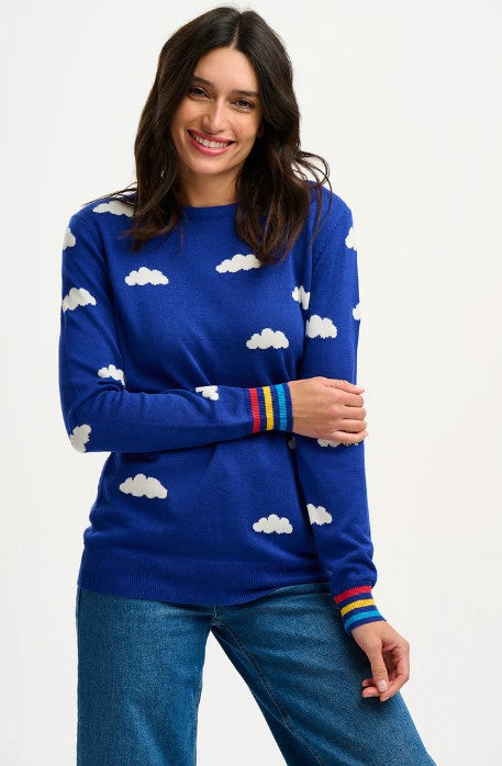 Royal blue sweater with cloud pattern and rainbow cuffs.
