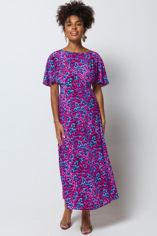Magenta and cobalt blue leopard print dress with cape sleeves.