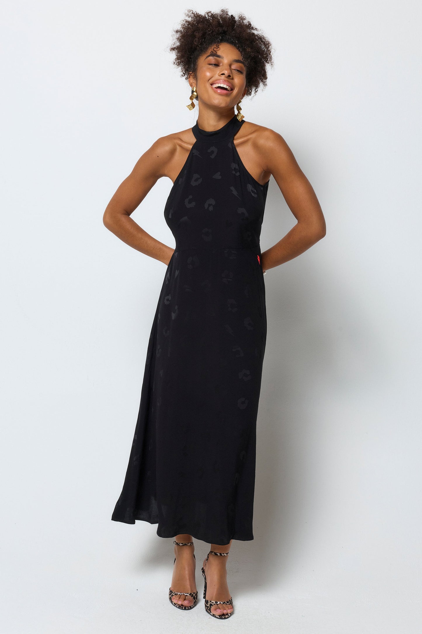 Black halterneck dress with leopard print pattern.