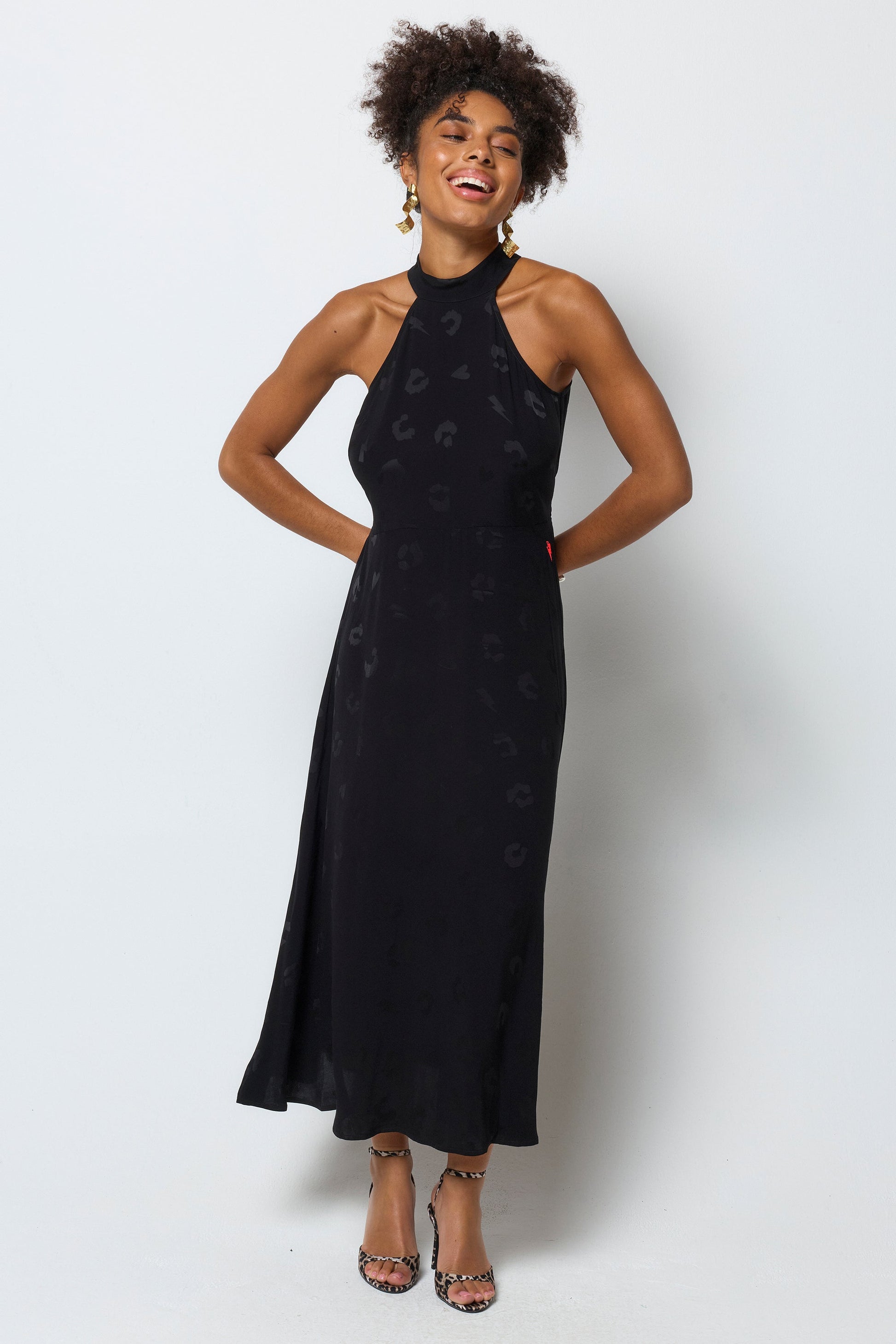 Black halterneck dress with leopard print pattern.