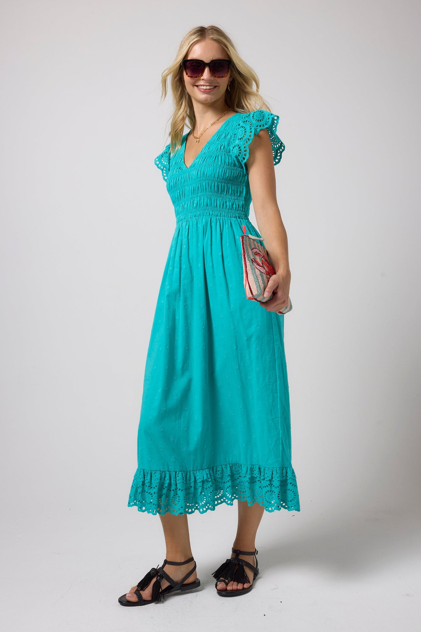 Turquoise shirred bodice midi dress with broderie anglaise detailing.