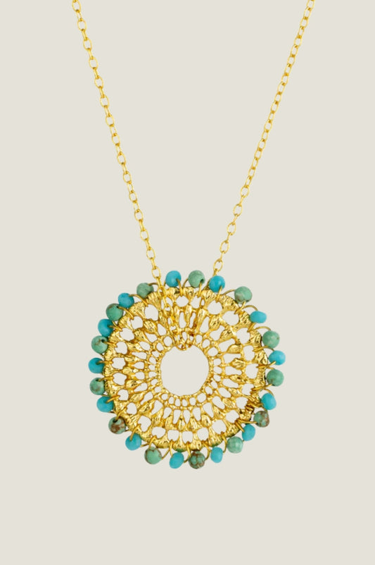 Gold dreamcatcher necklace with turquoise beads.