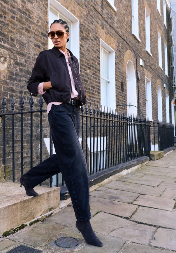 Washed black denim barrel leg jeans in organic cotton by Baukjen.