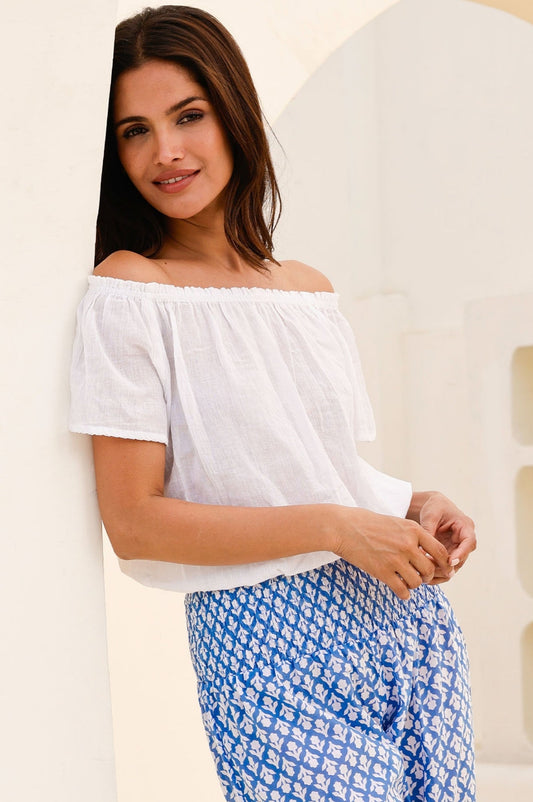 White organic cotton off-the-shoulder blouse.