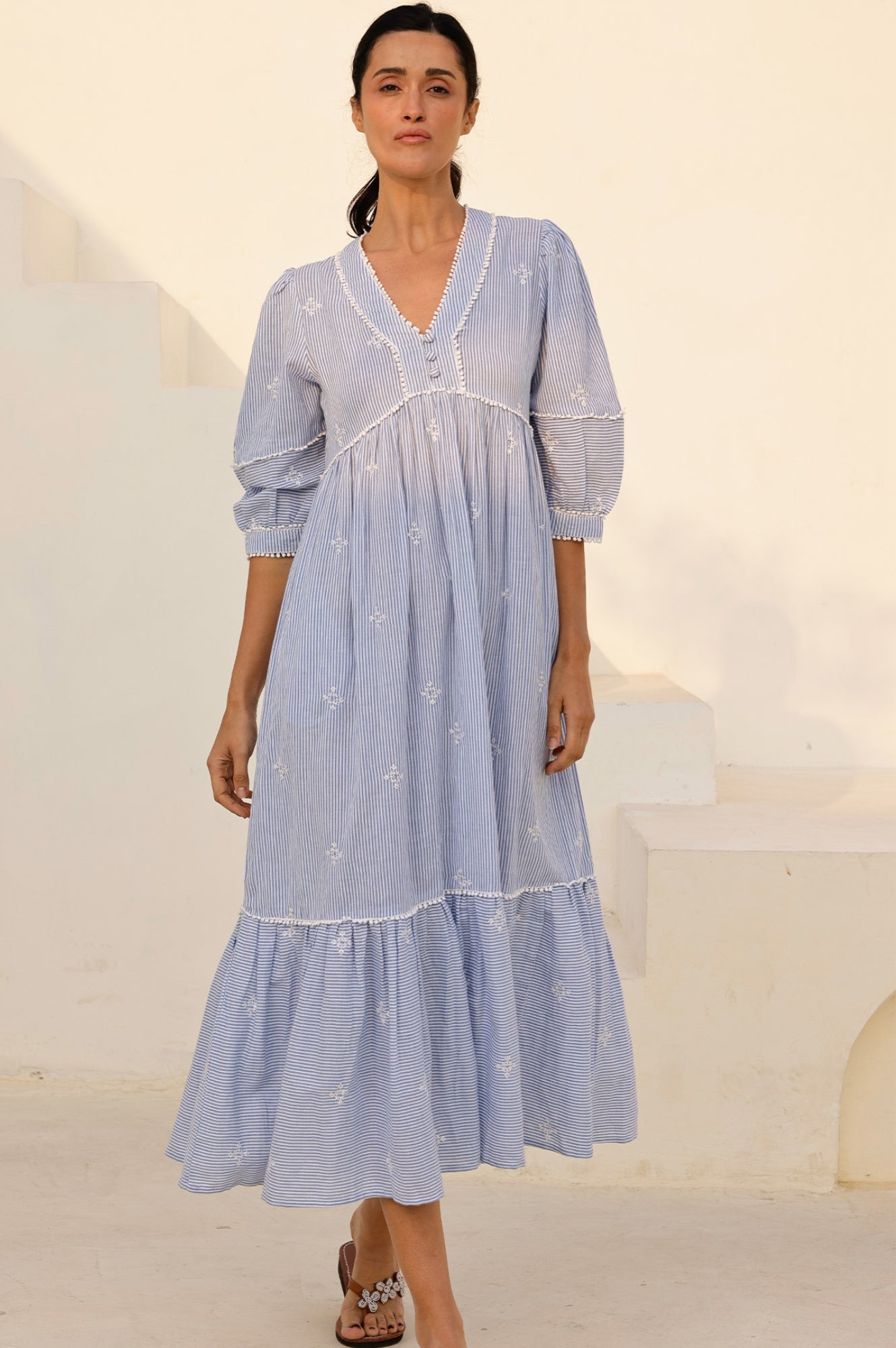 Organic cotton blue and white striped dress with buttons and piping.