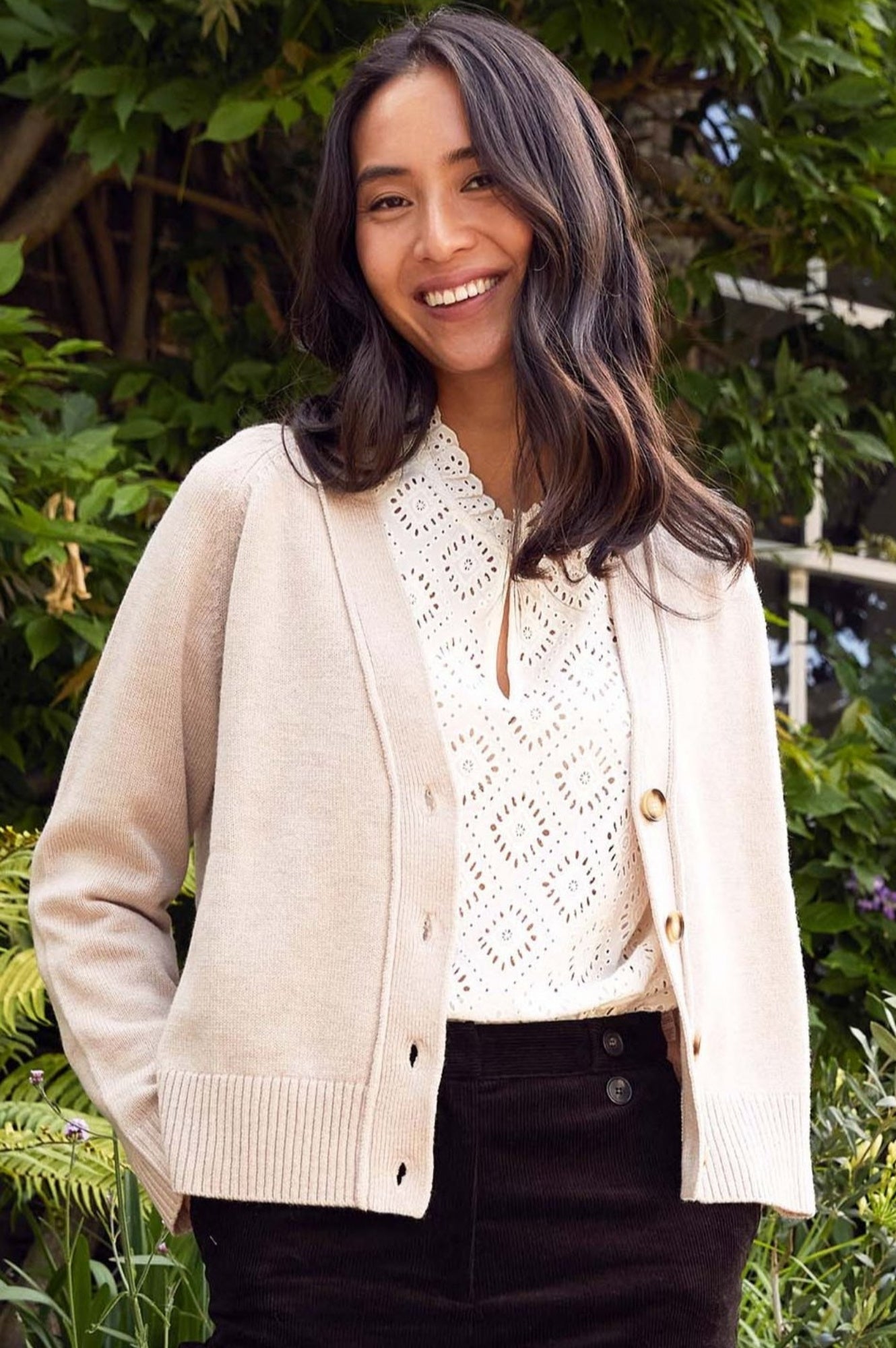 Soft beige button-through cardigan with round neckline, long sleeves, and ribbed hem and cuffs.