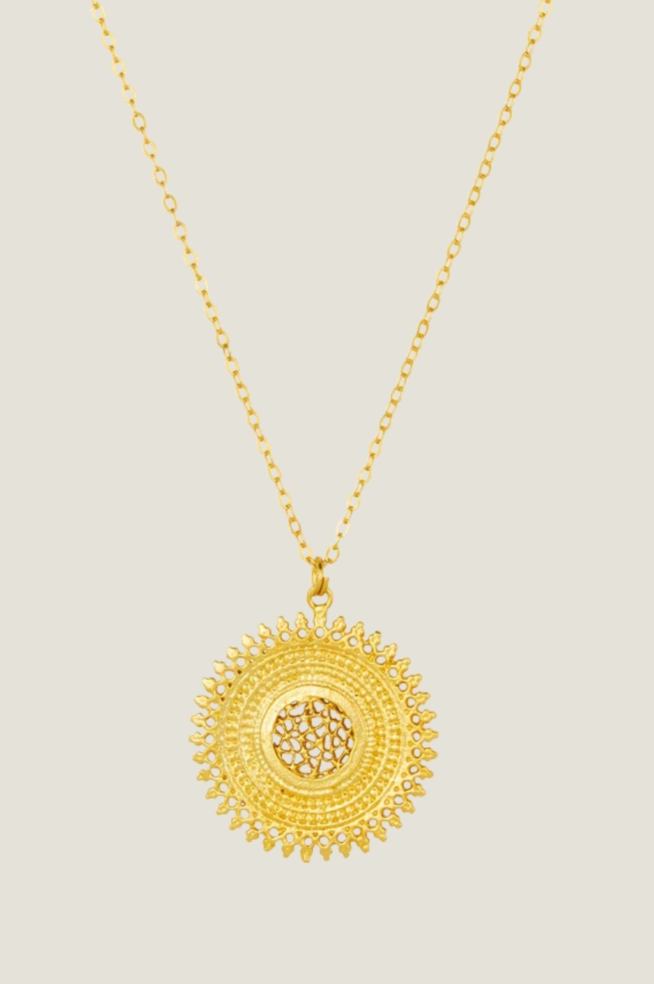 Gold sunburst pendant necklace.