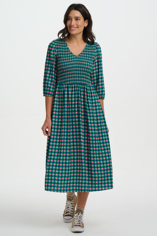 Shirred midi dress in 100% LENZING ECOVERO viscose, with pink and navy heart pattern over a green background.