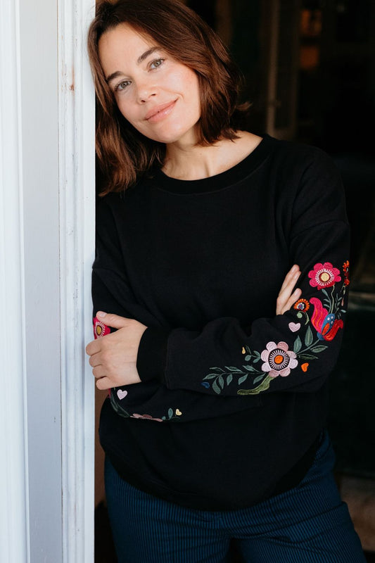 Black 100% cotton sweatshirt from Sugarhill Brighton, with embroidered floral sleeves.