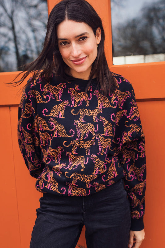 Black 100% cotton sweatshirt with pattern of pink and orange leopards, by Sugarhill Brighton.