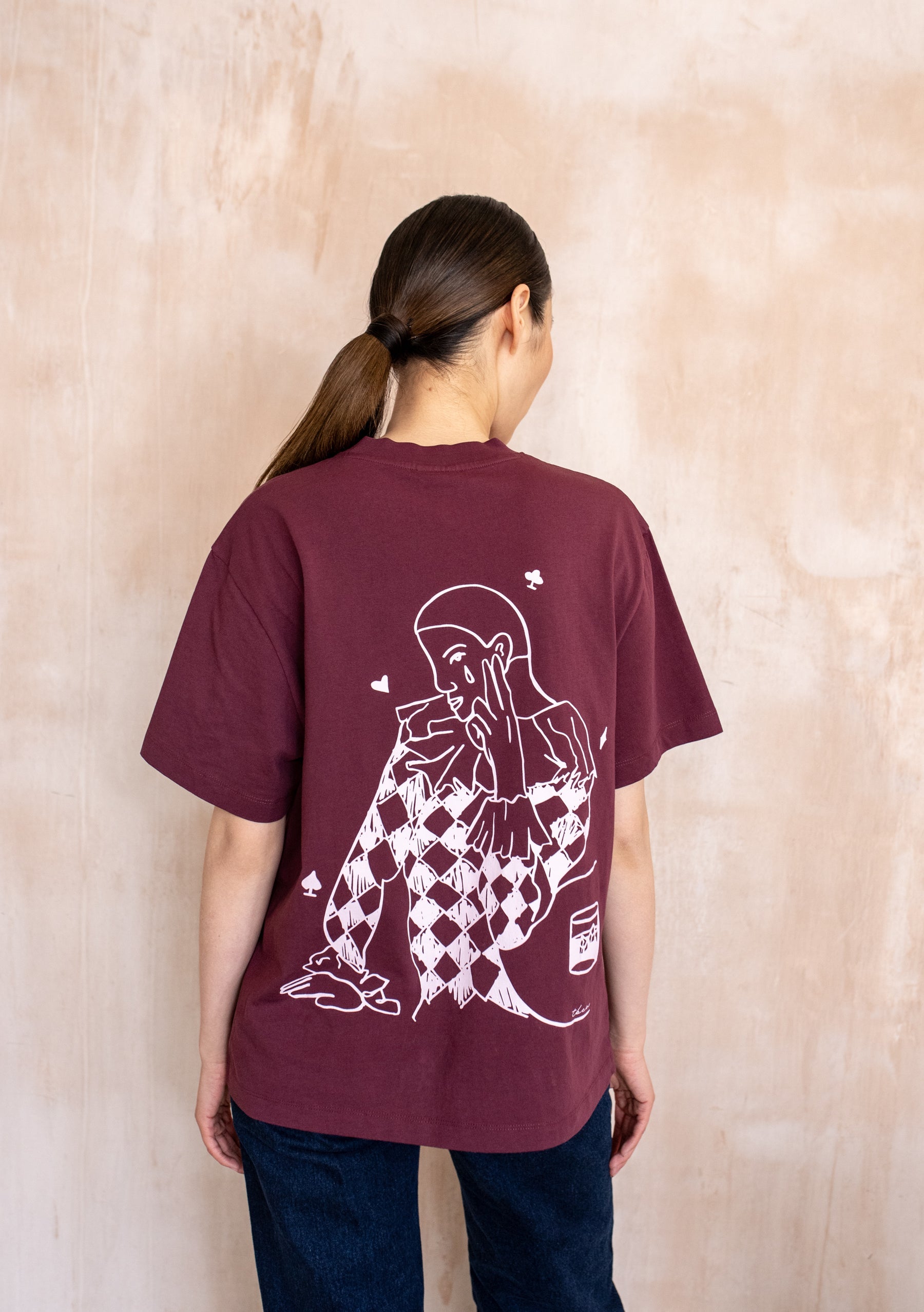Burgundy short sleeve t-shirt with small chest graphic and large white illustrated print on the back, relaxed fit