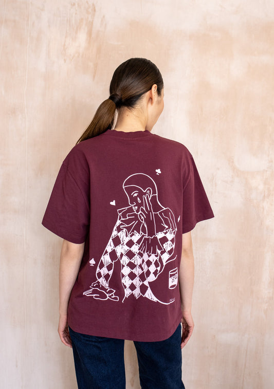 Burgundy short sleeve t-shirt with small chest graphic and large white illustrated print on the back, relaxed fit