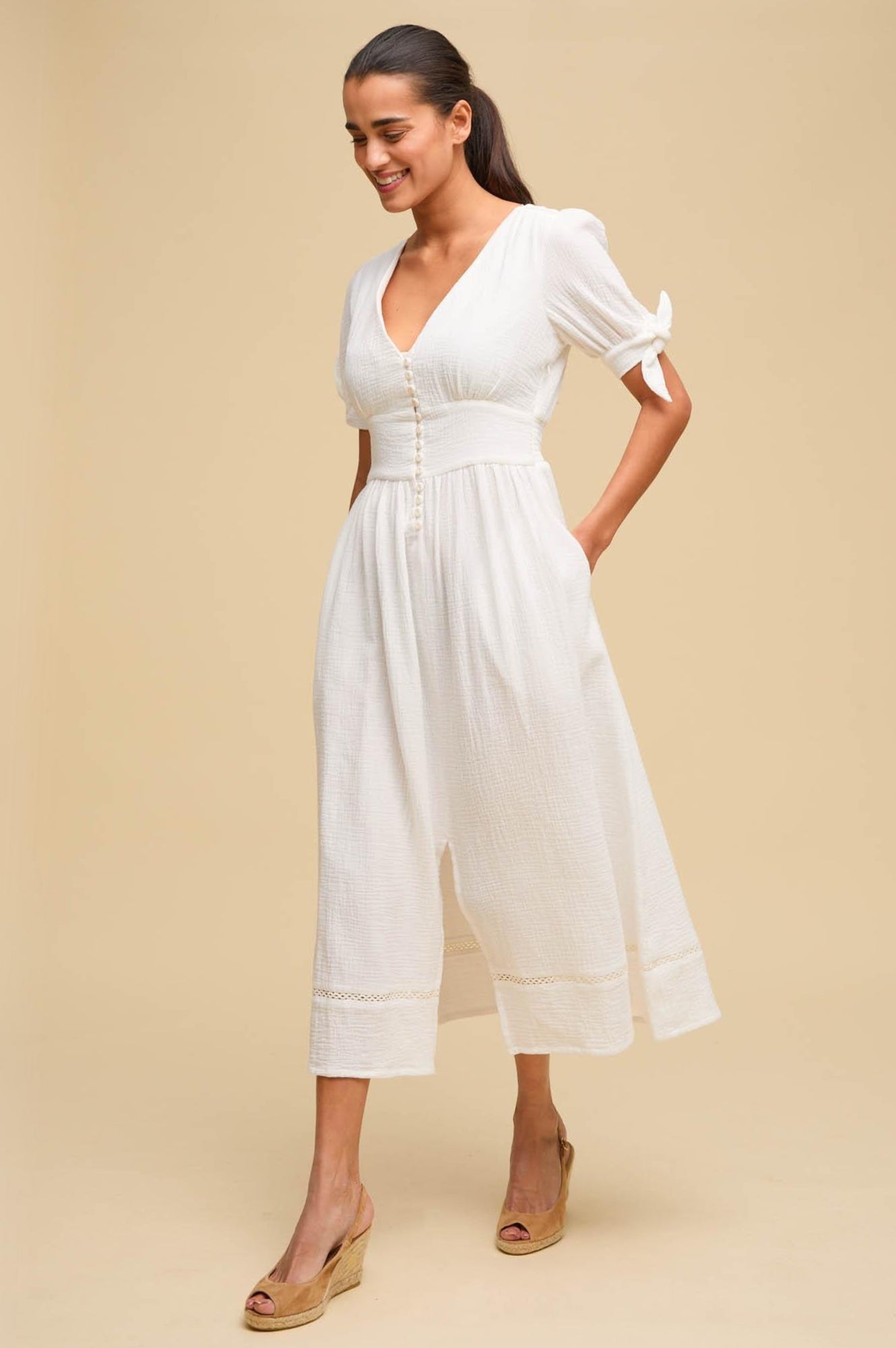 White cheesecloth cotton dress with tie sleeves and button down front.