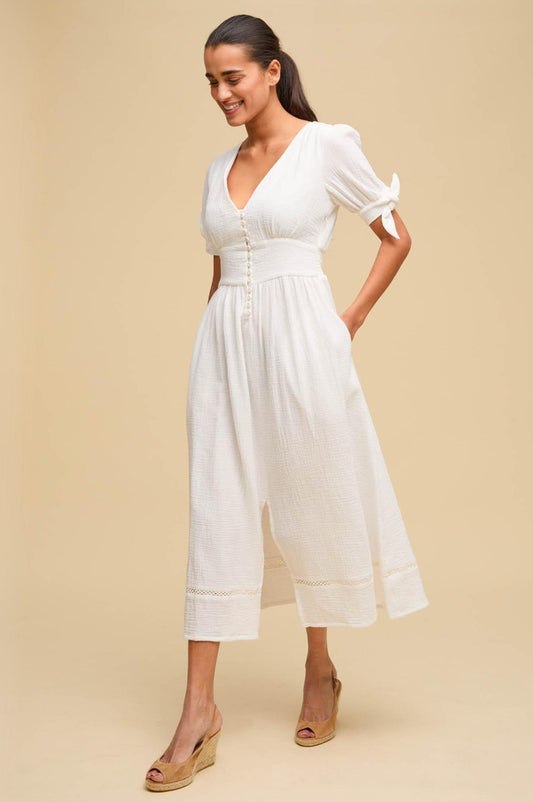 White cheesecloth cotton dress with tie sleeves and button down front.