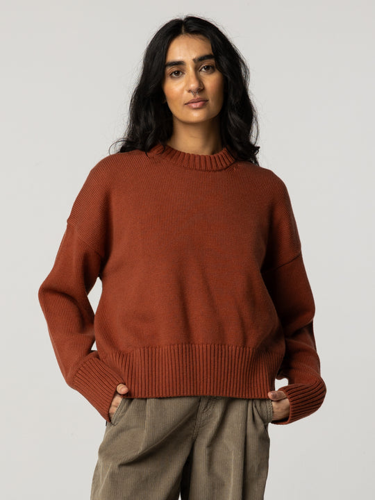 Organic cotton and merino blend rust red coloured round neck jumper.