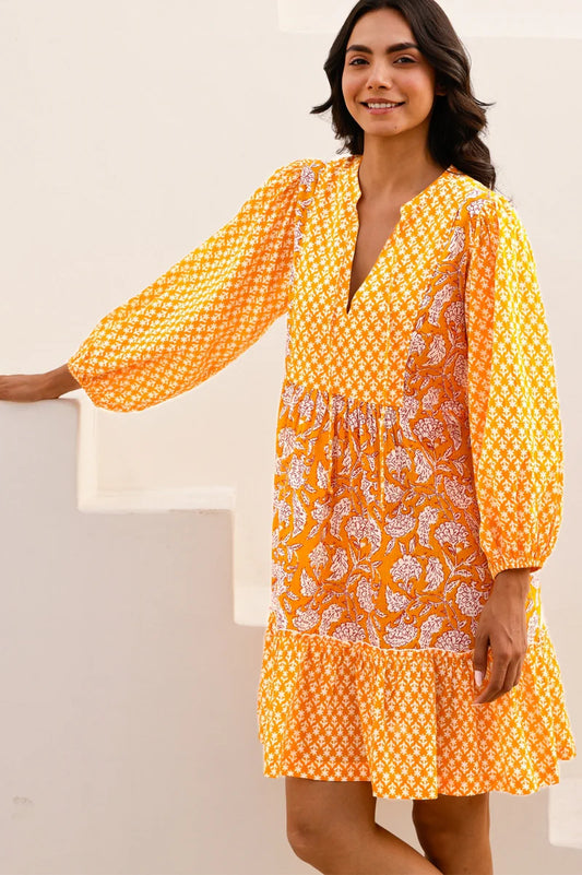 Woman wearing a yellow floral dress against a white background. This organic cotton kaftan from Aspiga has been filtered for the Clear Spring, Warm Spring, and Light Spring colour seasons by Shop My Palette.