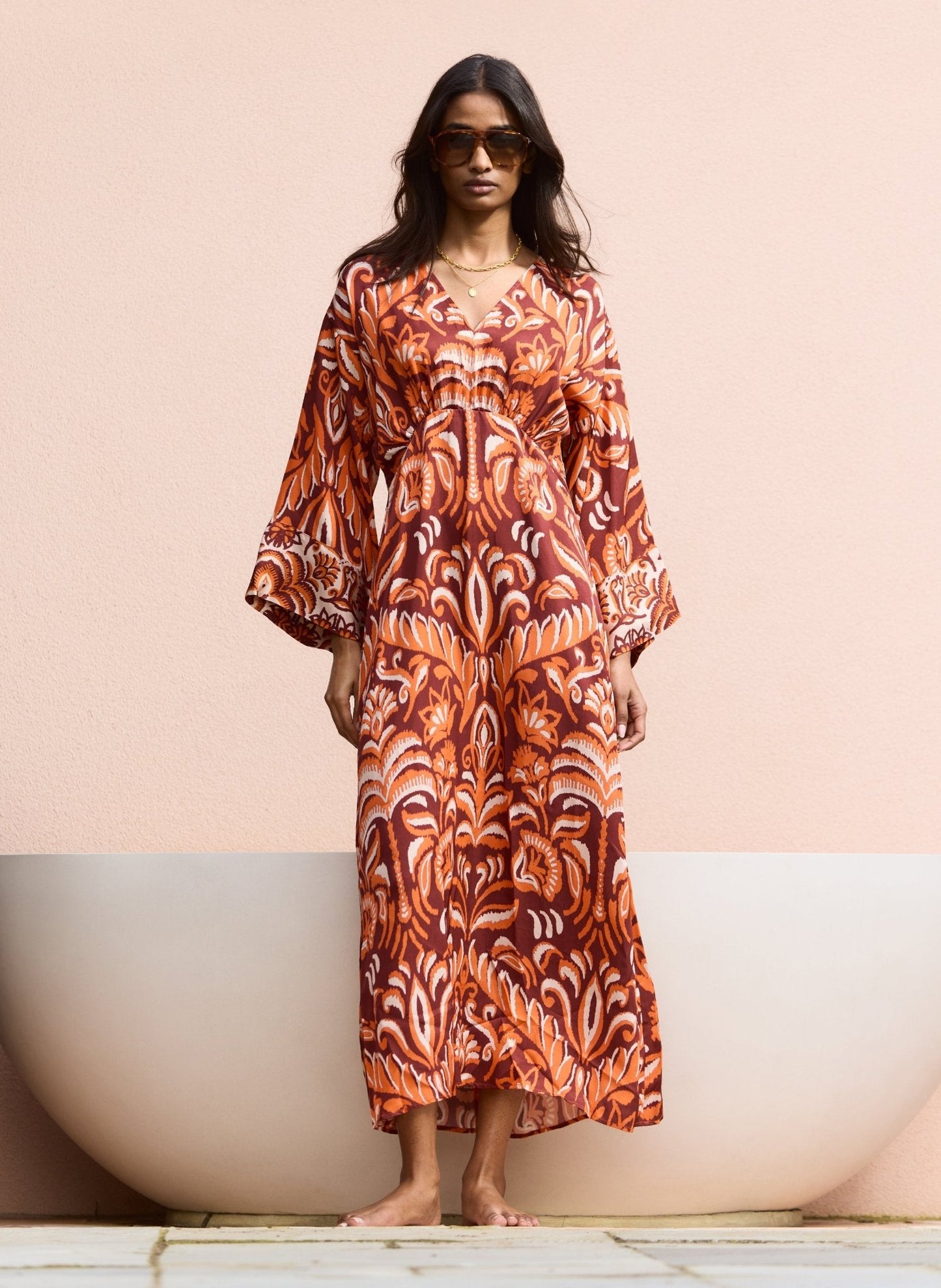 Burgundy kaftan with floral palm print.