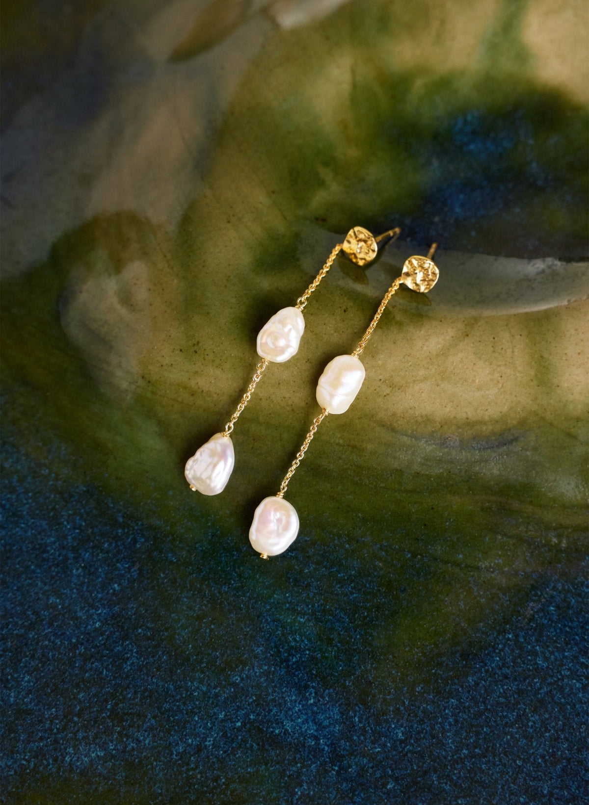 Gold chain pearl drop earrings with hammered gold disks.