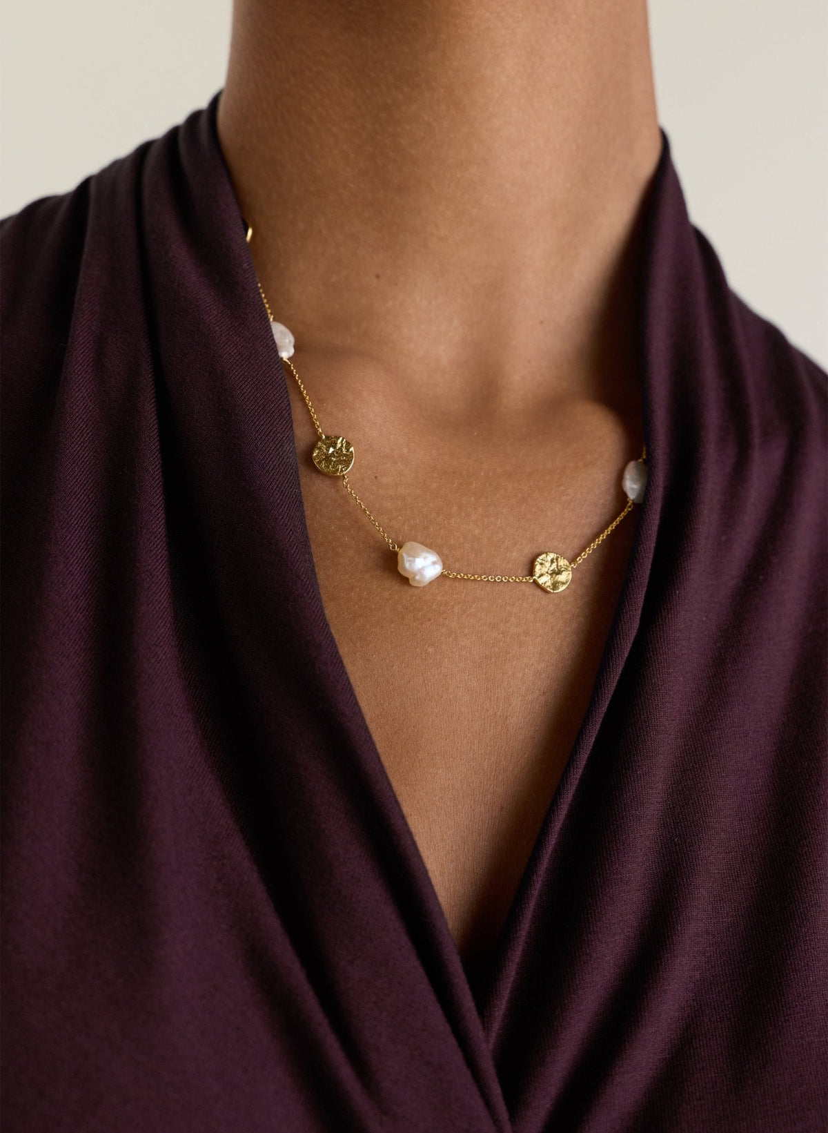 Gold chain necklace with hammered gold disks and freshwater pearls.