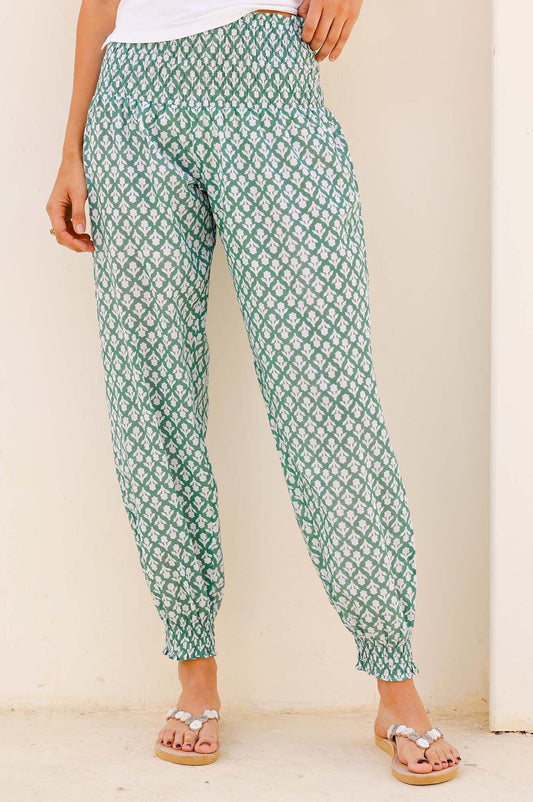 Green and white patterned harem trousers with elastic waistband, tapered leg, and cuffed ankles.