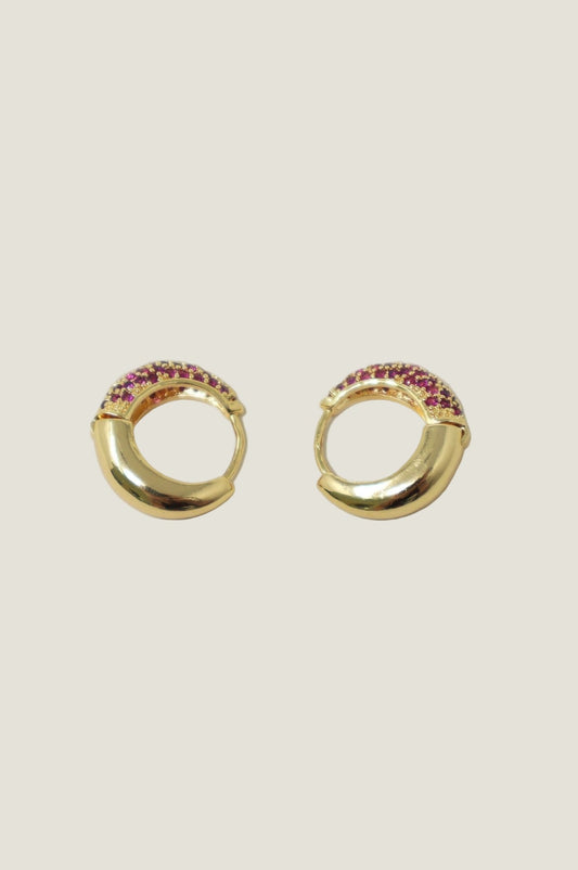 Gold hoop huggie earrings with ruby gemstone detail and chunky curved design.