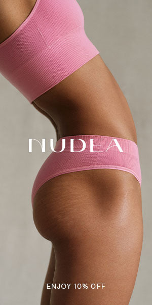 Person wearing pink underwear with 'NUDEA' branding on a neutral background