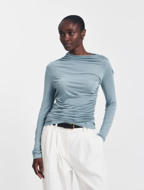 Long sleeved draped top in powder blue.