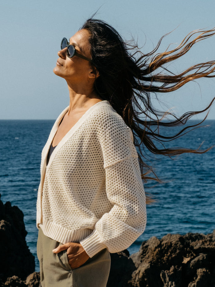 Ecru open knit organic cotton cardigan.