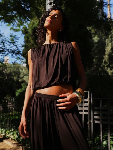 Dark chocolate brown vest top with puff ball hem.
