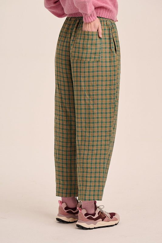 Green and tan check trousers with elasticated waist, straight leg silhouette, and lightweight woven fabric.