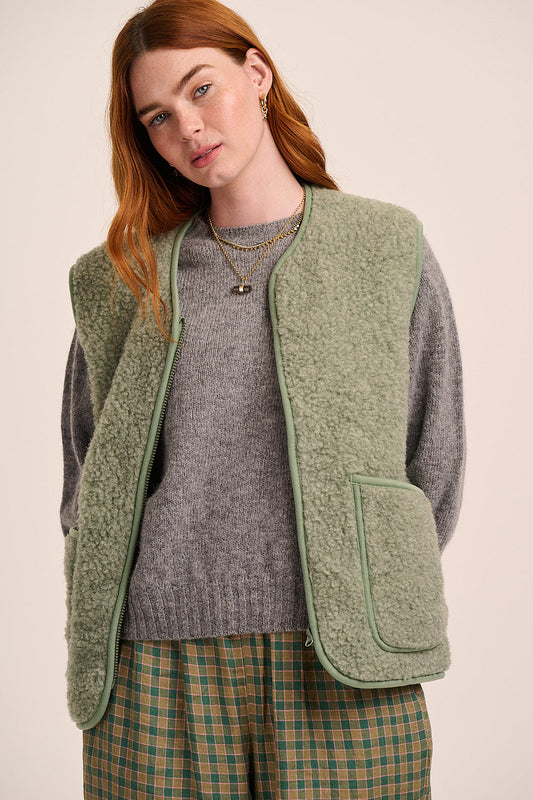 Light sage green fleece gilet with sleeveless design, zip front, patch pockets, and soft textured finish.
