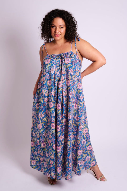 Blue floral maxi dress with thin tie straps, gathered neckline, loose flowing silhouette, and lightweight fabric