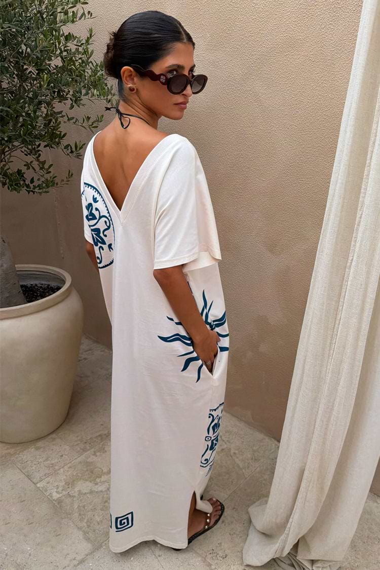 Cream maxi dress with blue placement print, V-back neckline, short sleeves, and relaxed straight silhouette