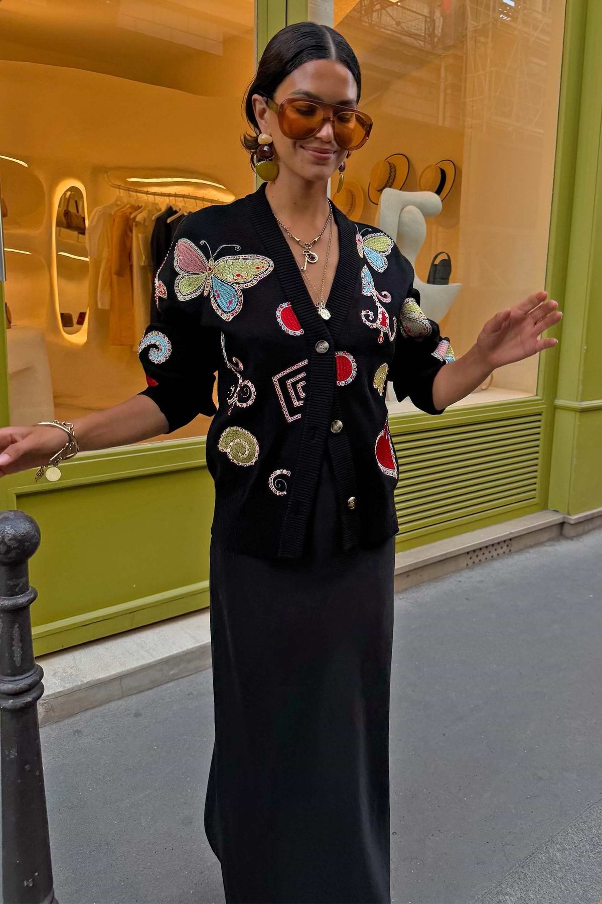Black cardigan with graphic print embroidery.