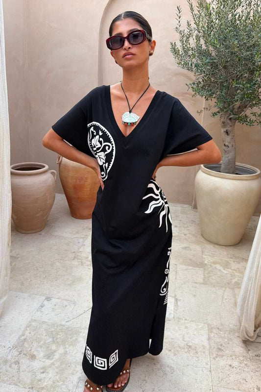 Black V-neck maxi dress with short sleeves, white contrast print detailing, and relaxed straight silhouette